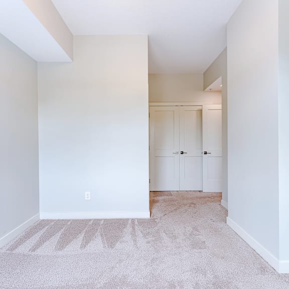 a room with white walls and a carpet with a design on it.