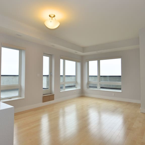 a large empty room with wooden floors and white walls.