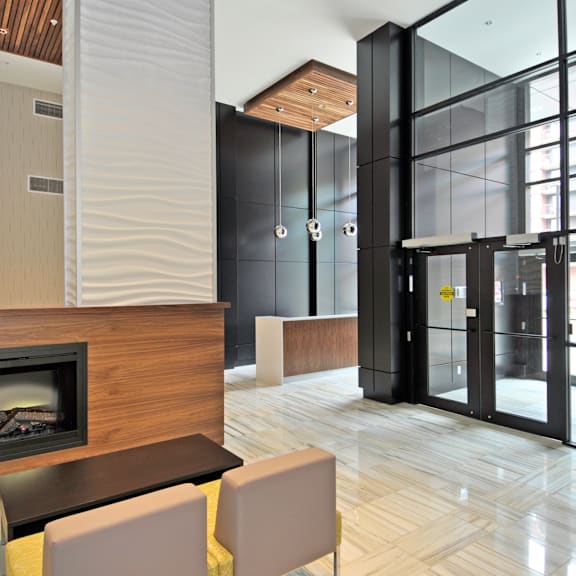 a modern living room with a fireplace and a glass door.