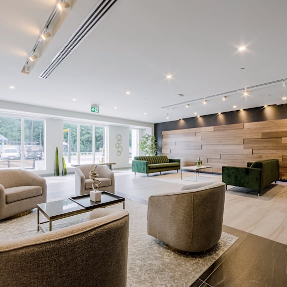 a modern living room with a glass table and comfortable seating.