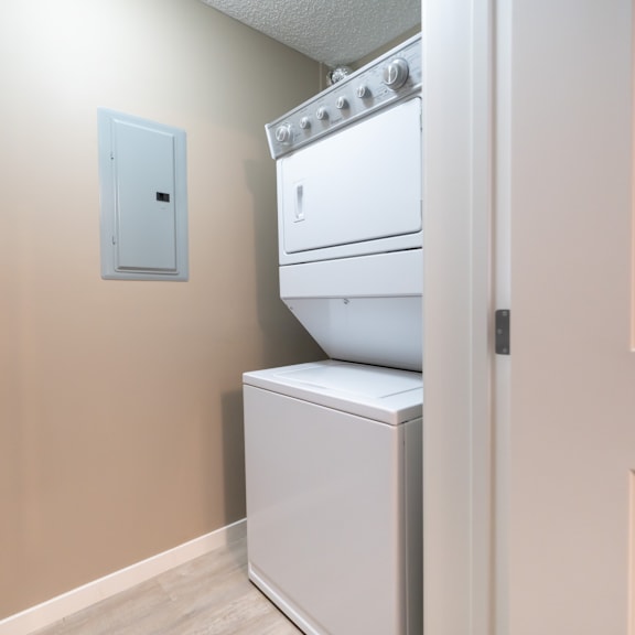 a white dishwasher and oven in a kitchen.
