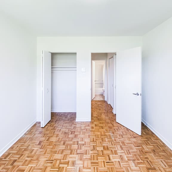 a room with a wooden floor and white walls.