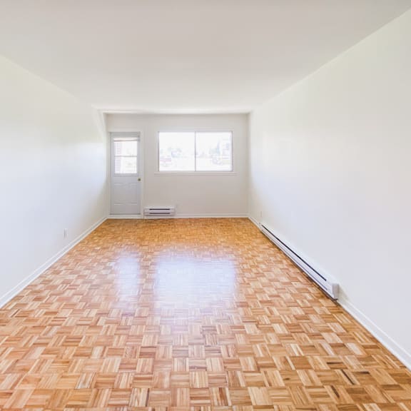 a room with a wooden floor and a white door.