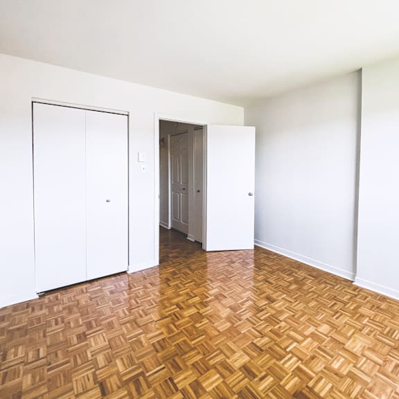 a room with a wooden floor and white walls.