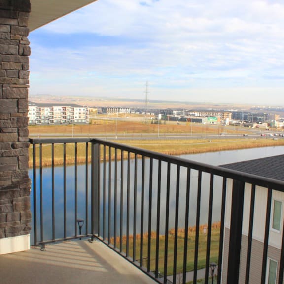 a balcony with a view of a field and buildings.