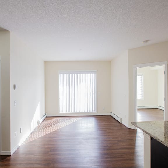 a large empty room with wooden floors and white walls.