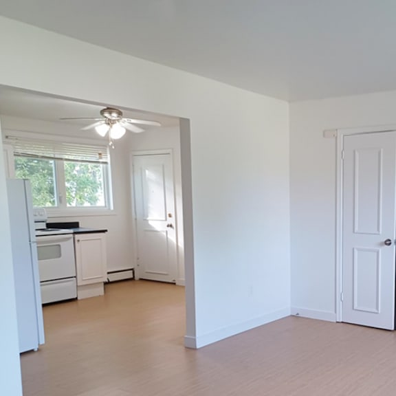 a white room with a door and a window.