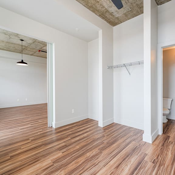 a room with wooden floors and white walls.