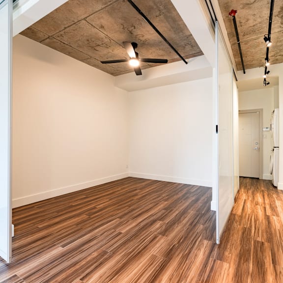 a room with wooden flooring and a ceiling fan.