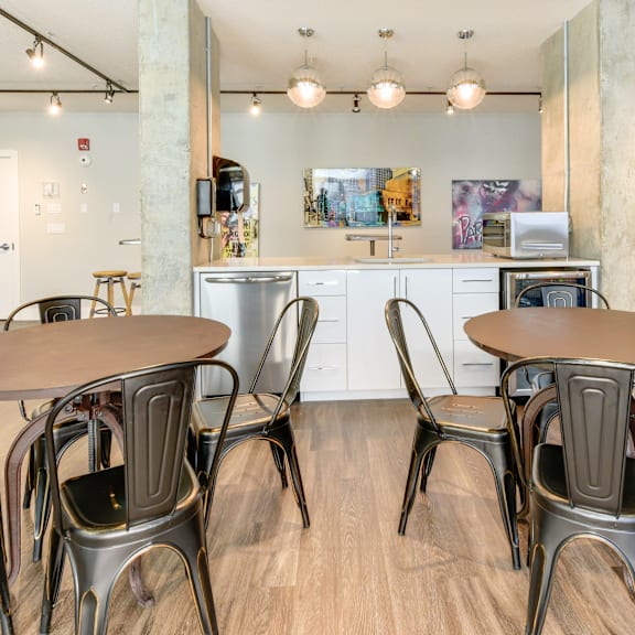 a modern kitchen with a dining table and chairs.