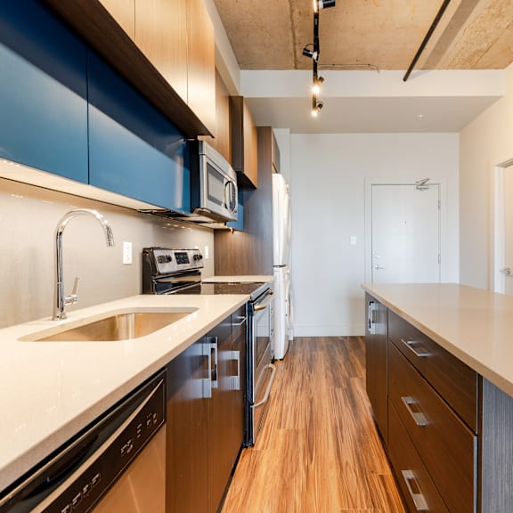 a kitchen with wooden floors and a white counter top.