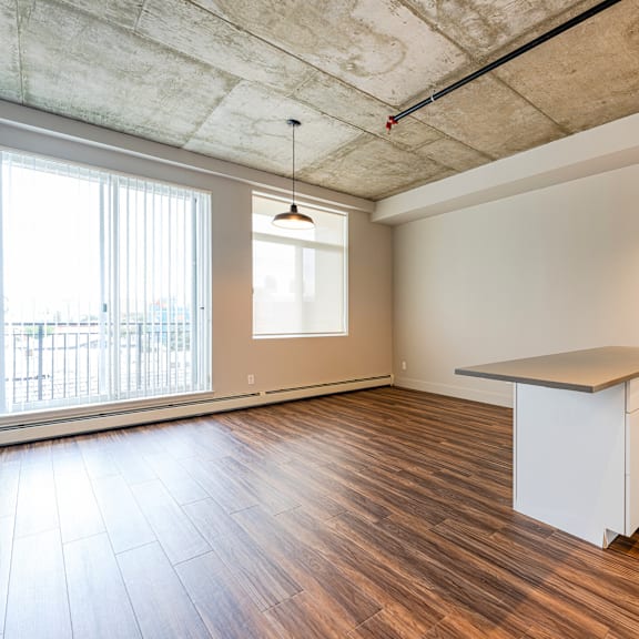 a room with a white cabinet and a window with blinds.
