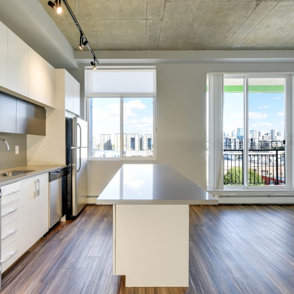 a modern kitchen with a large island in the middle.