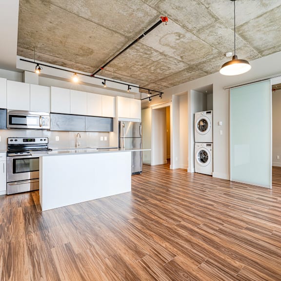 a kitchen with a white countertop and stainless steel appliances.