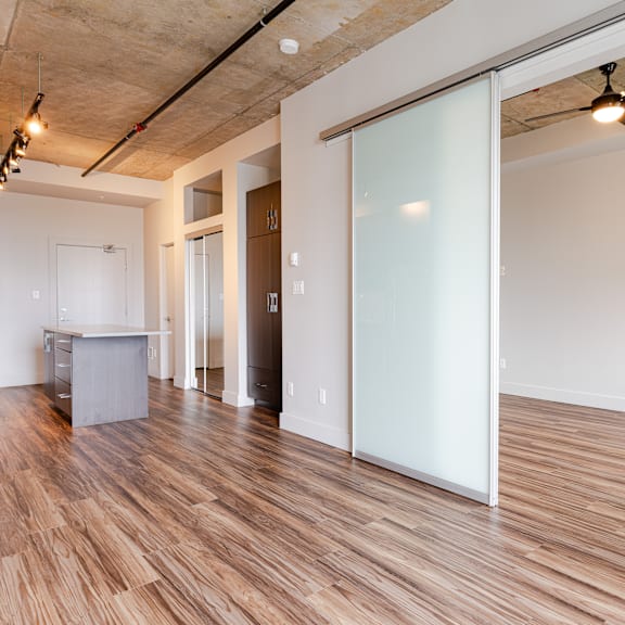 a room with a wooden floor and a white wall.