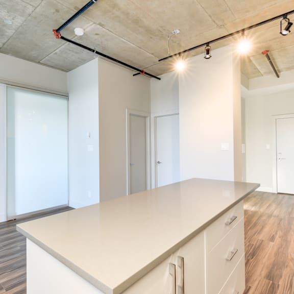 a kitchen with a large island and white cabinets.