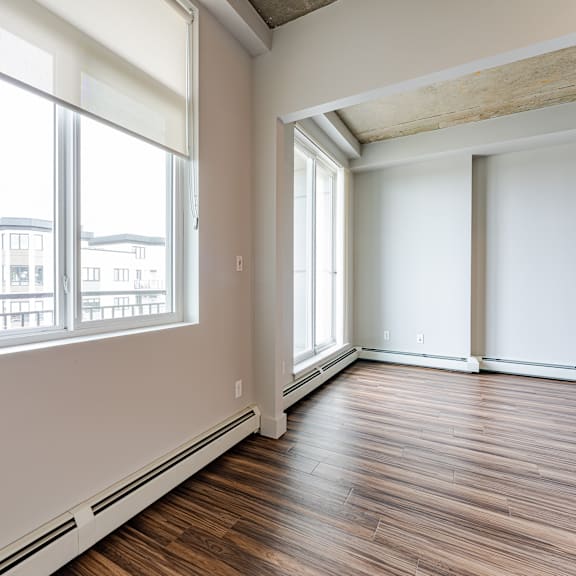 a room with wooden floors and white walls.
