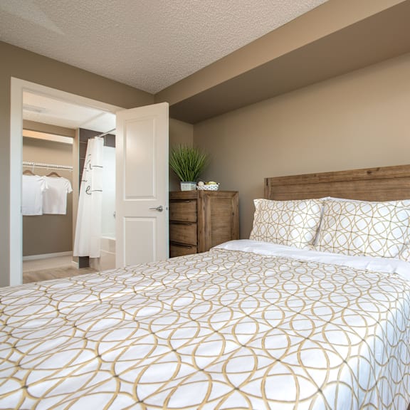 a bedroom with a large bed and a wooden headboard.