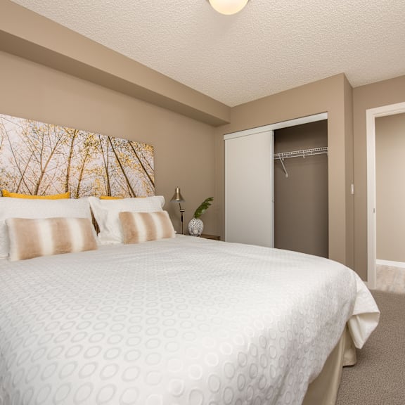 a bedroom with a large bed and a painting on the wall.