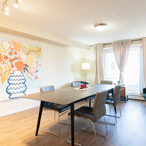 a dining room with a table and chairs.