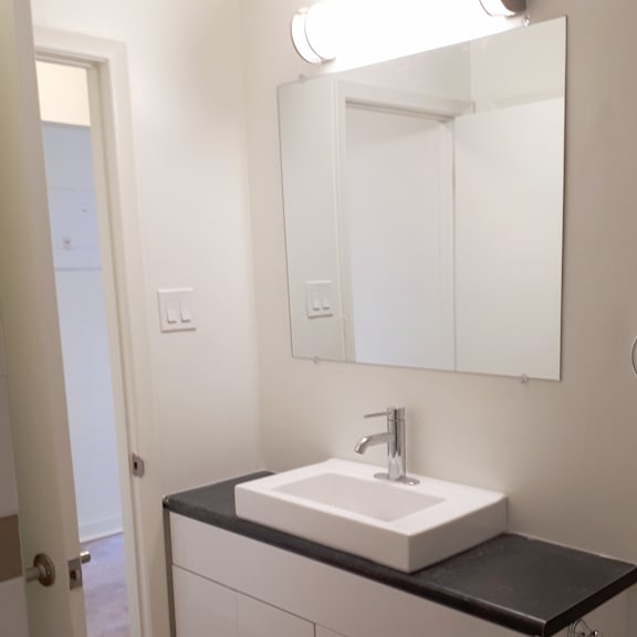 a bathroom with a sink and mirror.