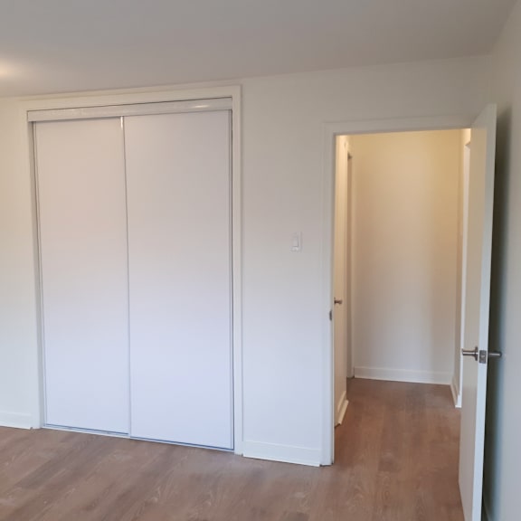 a room with a white door and a white wall.