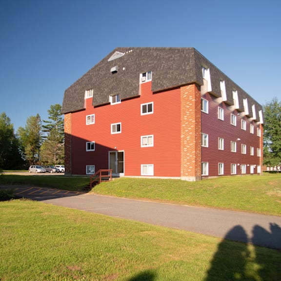a red brick building with a black roof and white trim.
