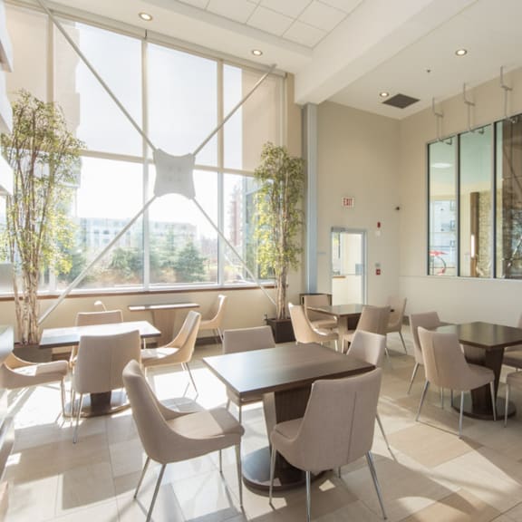 a modern dining room with large windows and a view of the city.