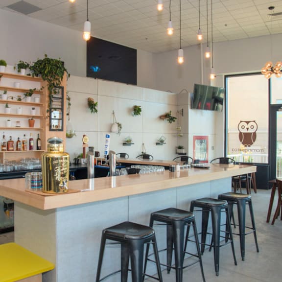a bar with a yellow stool and a white counter.