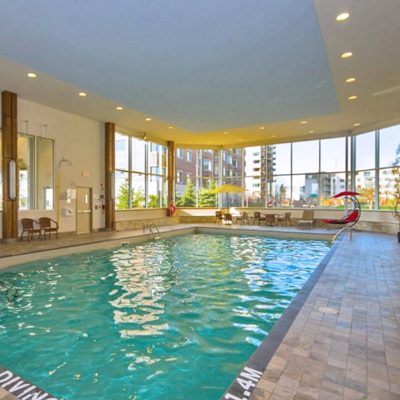 a large indoor swimming pool with a "no diving" sign.