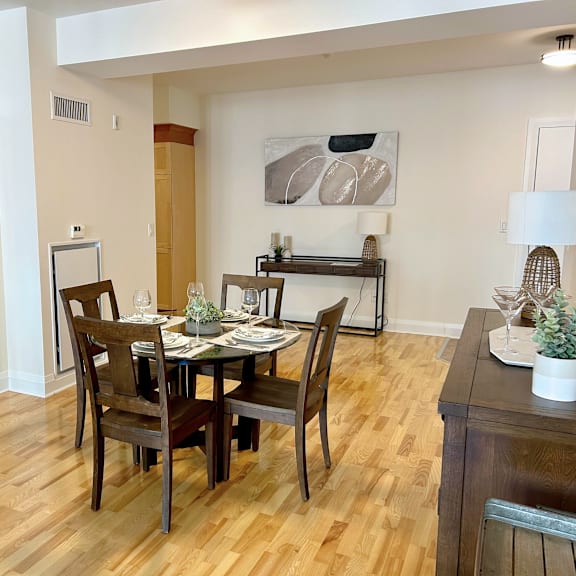 a dining room with a wooden table and chairs.
