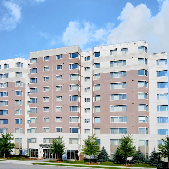 a large, modern building with a white and pink facade and multiple windows.