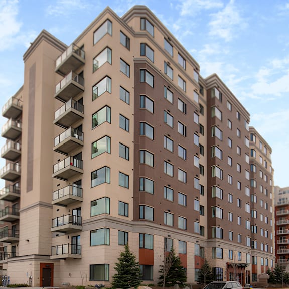 a large apartment building with balconies on the second floor.