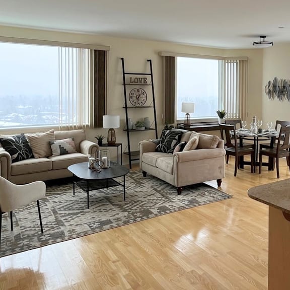 a living room with a large window and a view of the city.