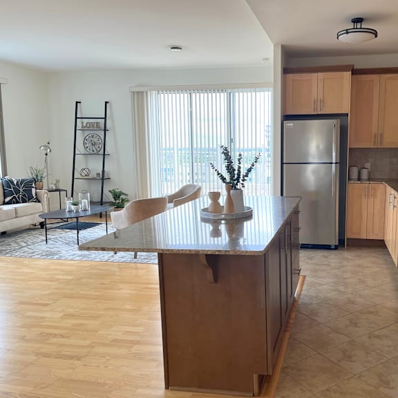 a kitchen with wooden cabinets and a large island in the middle.