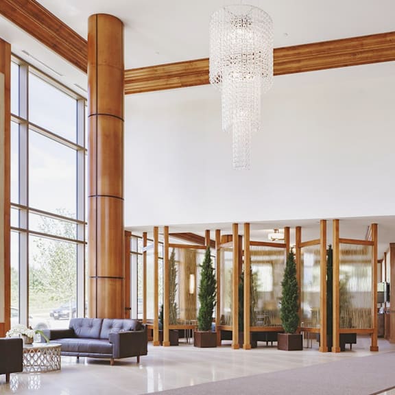 a large room with a blue sofa and a chandelier hanging from the ceiling.