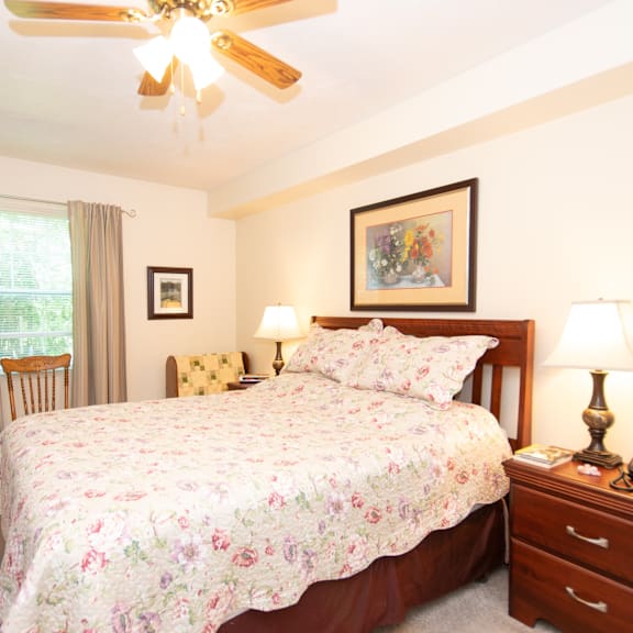 a bedroom with a large bed and a ceiling fan.