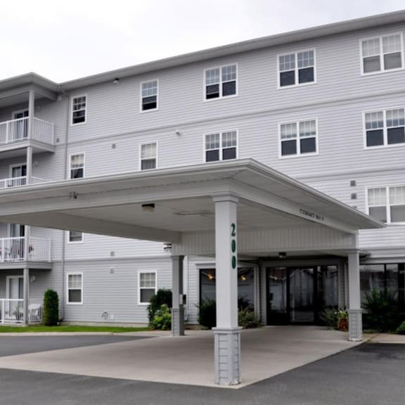 a large building with a covered walkway in front.