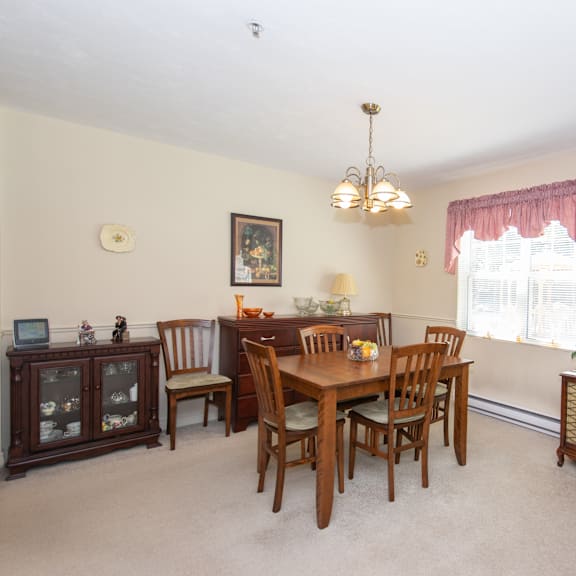 a dining room with a wooden table and chairs.