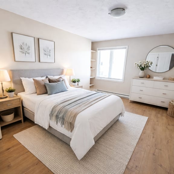 a bedroom with a large bed, a dresser, and a mirror.