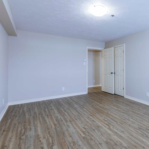 a room with wooden flooring and white walls.