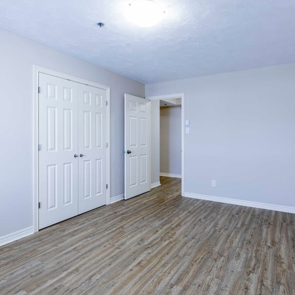 a room with two doors and a wooden floor.