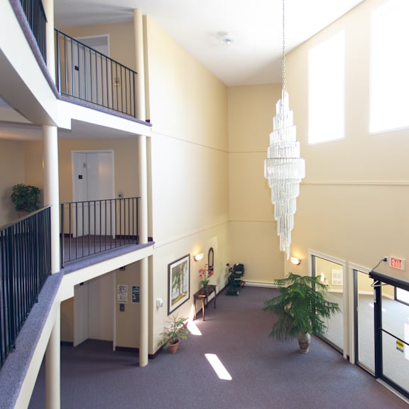 a large atrium with a chandelier hanging from the ceiling.