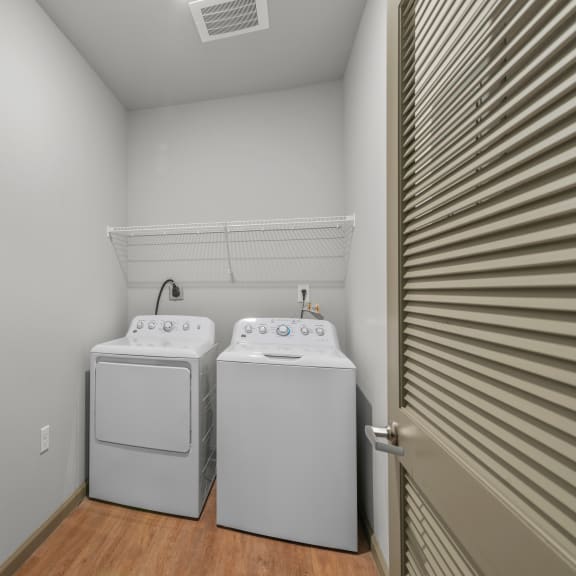 Thumbnail 5 of 7 a laundry room with two washers and a dryer in it