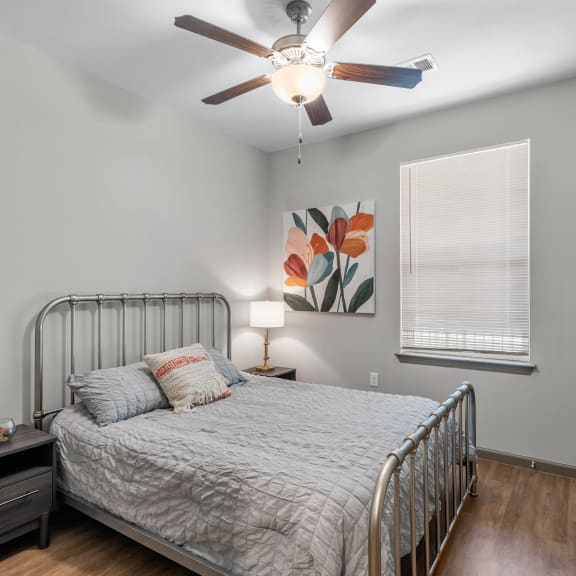 Thumbnail 7 of 7 a bedroom with a bed and a ceiling fan