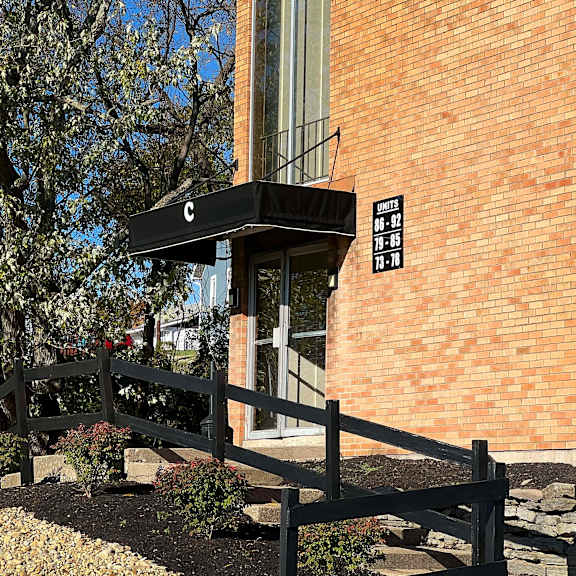 a wooden fence in front of a brick building at barkley ridge apartments, kentucky
