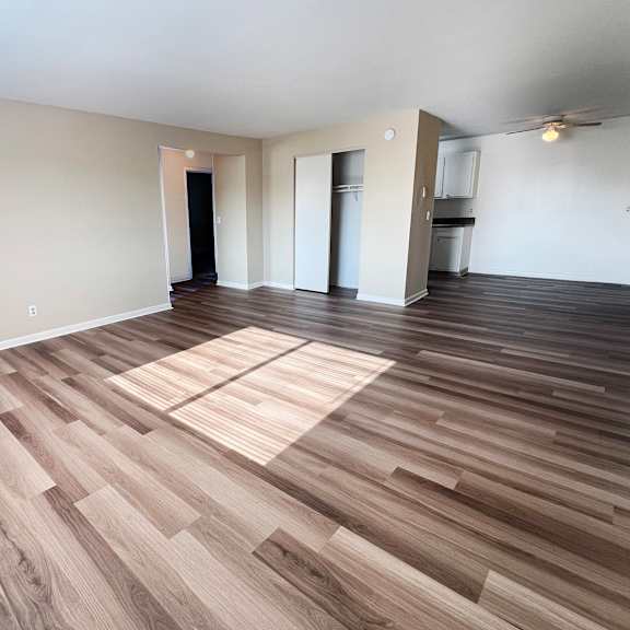 a room with wooden flooring and white walls.