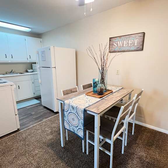 a kitchen with a table and chairs in the middle of the room.