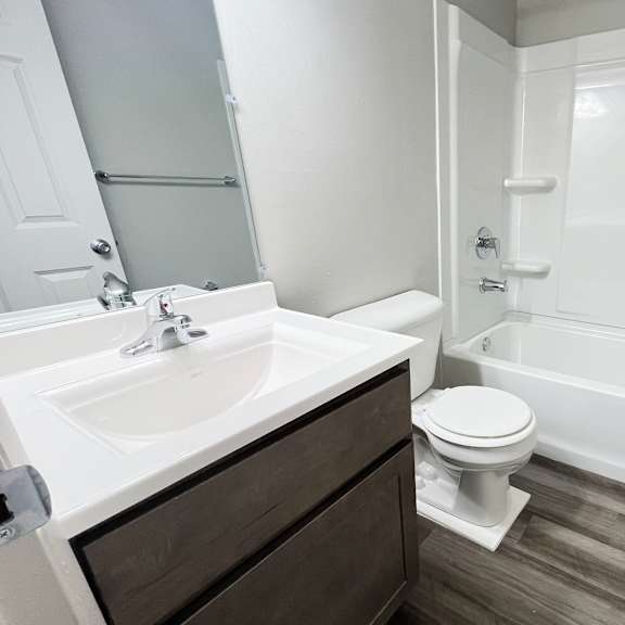 an empty bathroom with a sink toilet and shower at fox run apartments, cincinnati