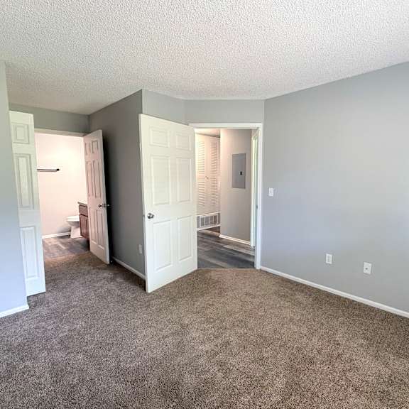 a room with carpeted floor and white walls.